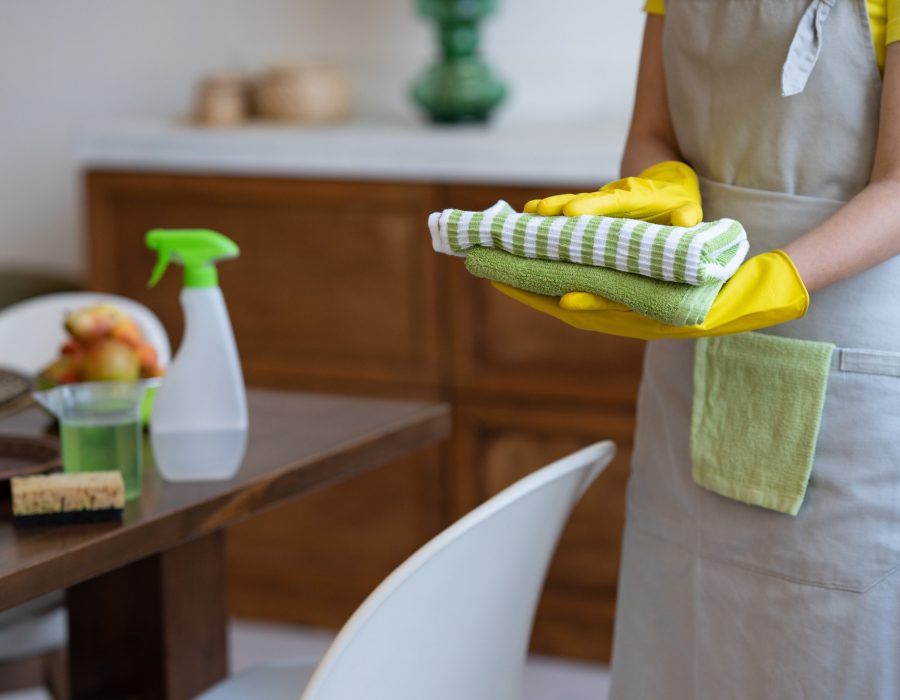 cleaning-service-a-woman-in-a-gray-apron-and-yellow-rubber-gloves-professional-cleaning.jpg