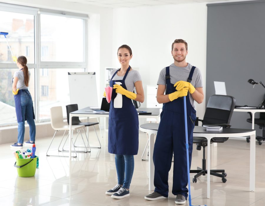 Team of janitors cleaning office